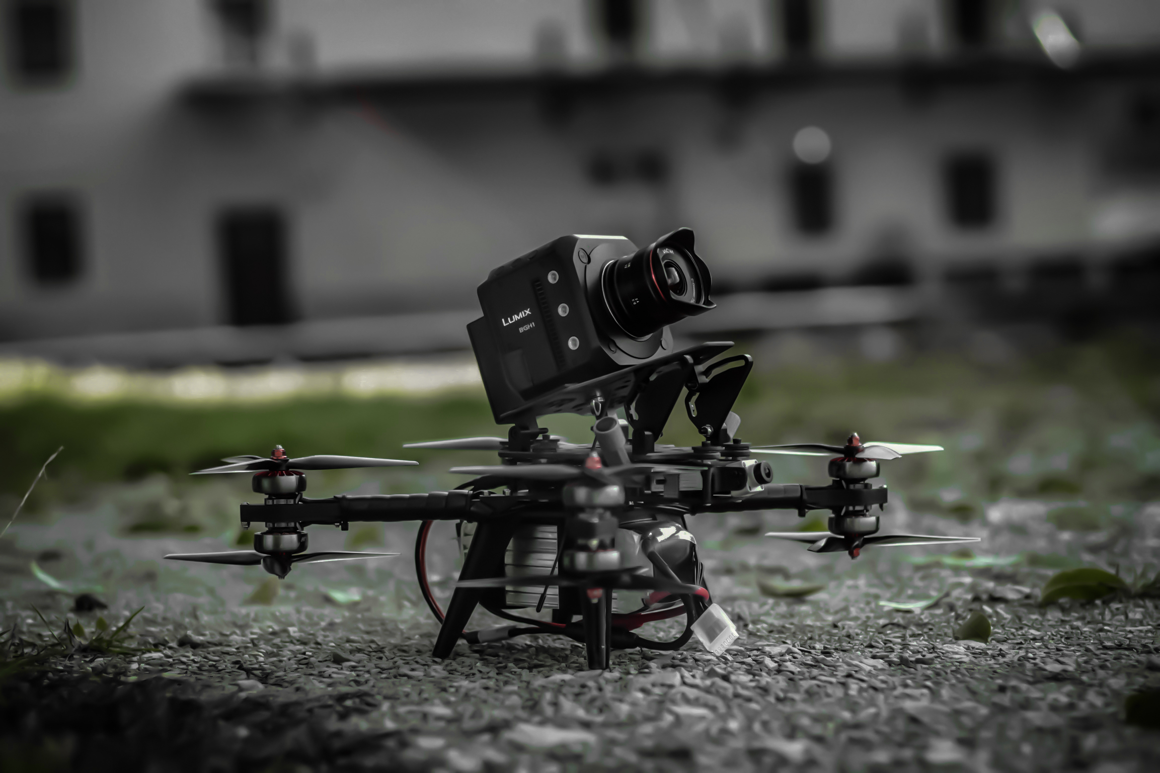 FPV-Cinelifter mit Kinokamera im Flug &uuml;ber einem Baufeld